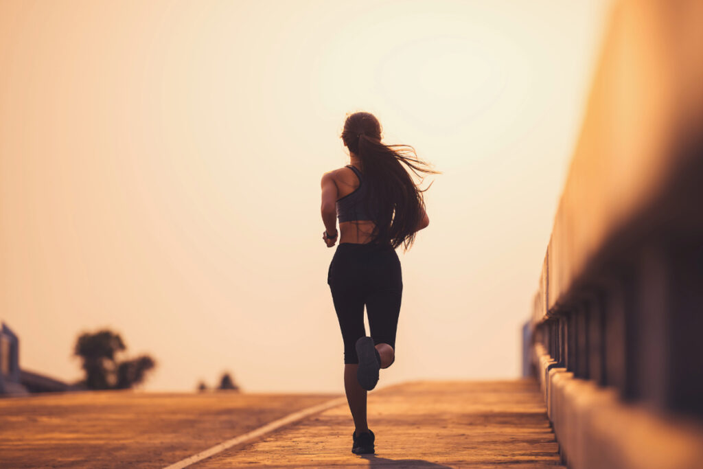 Athlete running down sidewalk