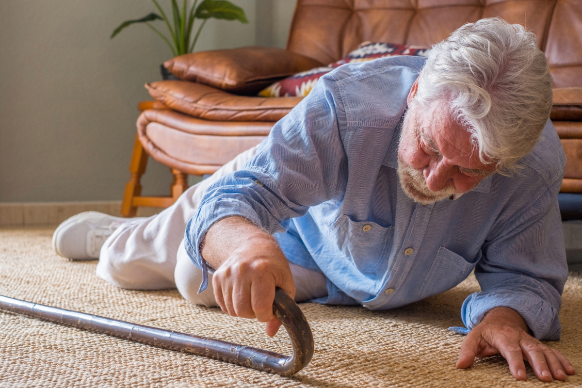 Senior lying on floor after falling